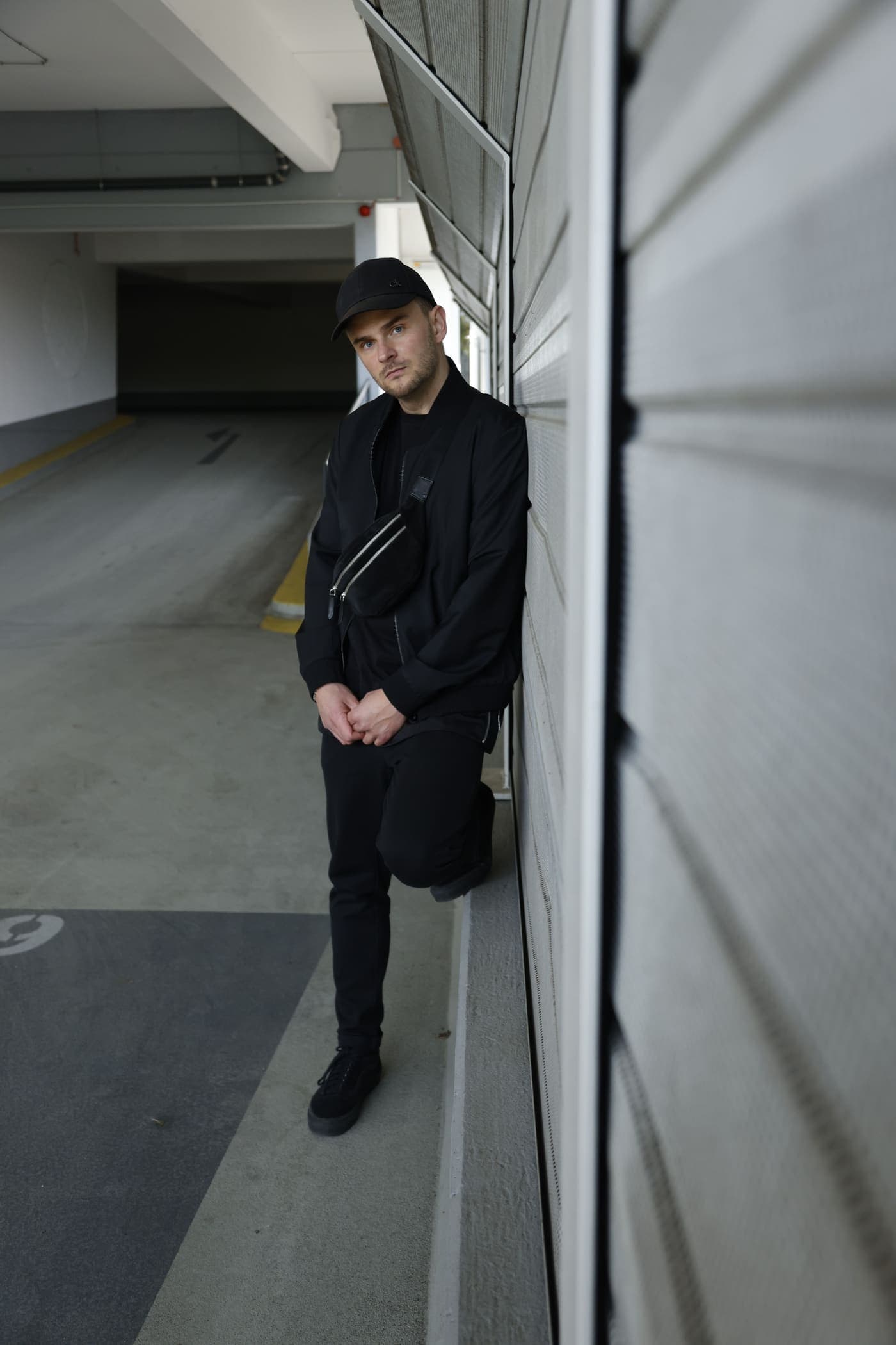 Goeran Meyer standing in a concrete underpass, full length