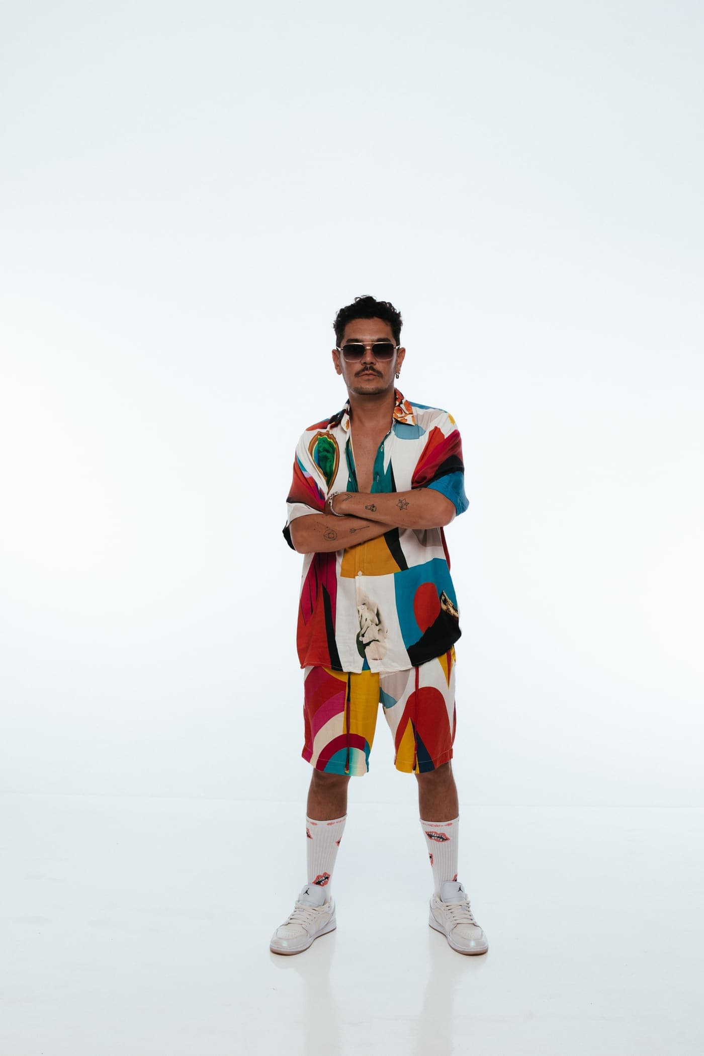 Kaiser Waldon full length in a colour-blocked outfit on white