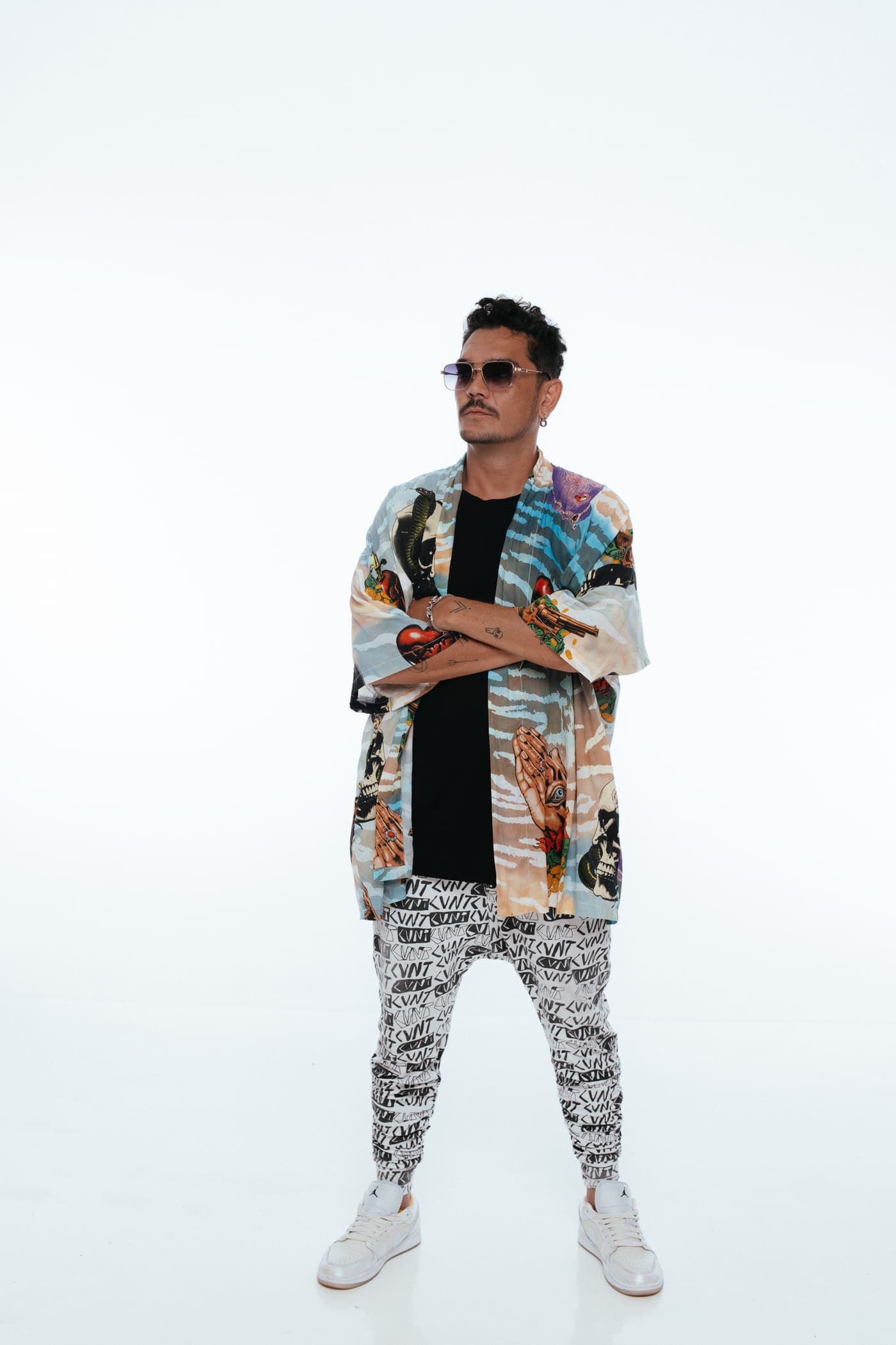 Kaiser Waldon full length in a printed jacket and trousers on white