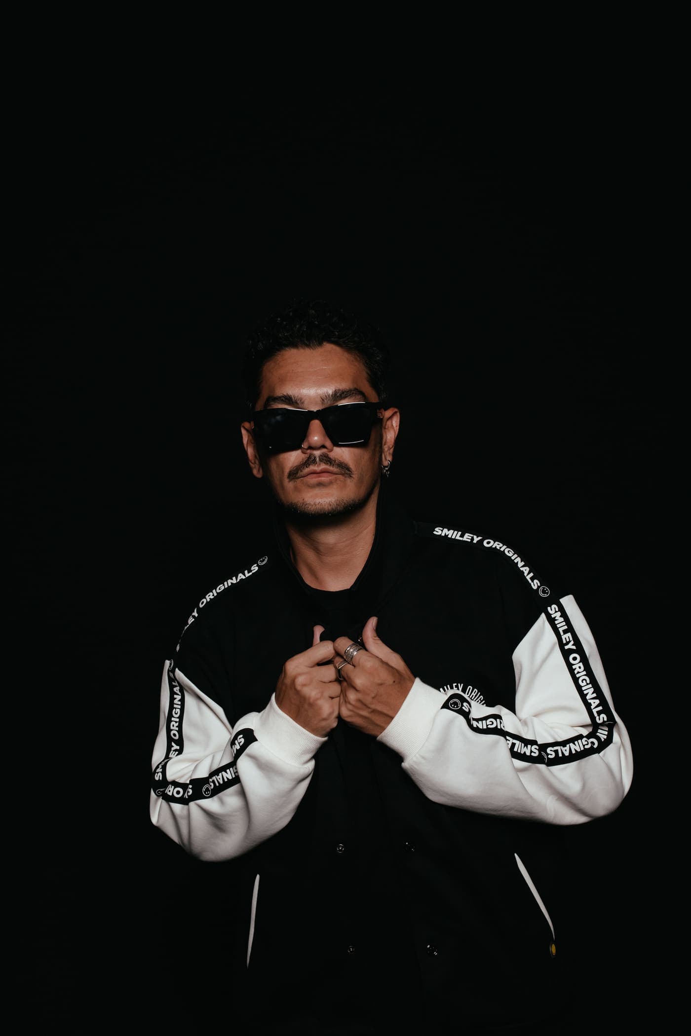 Kaiser Waldon in a monochrome patterned jacket against black