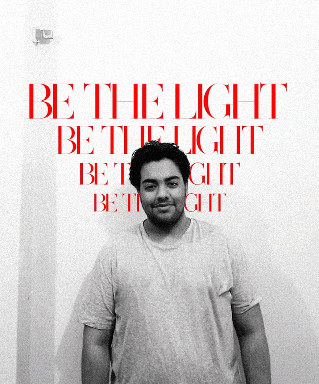 Ëyris in front of a poster reading BE THE LIGHT