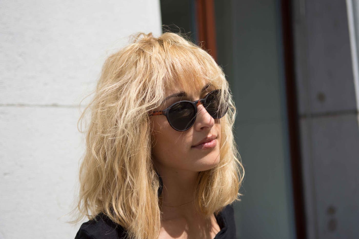 Juli Lee in sunglasses in front of a doorway