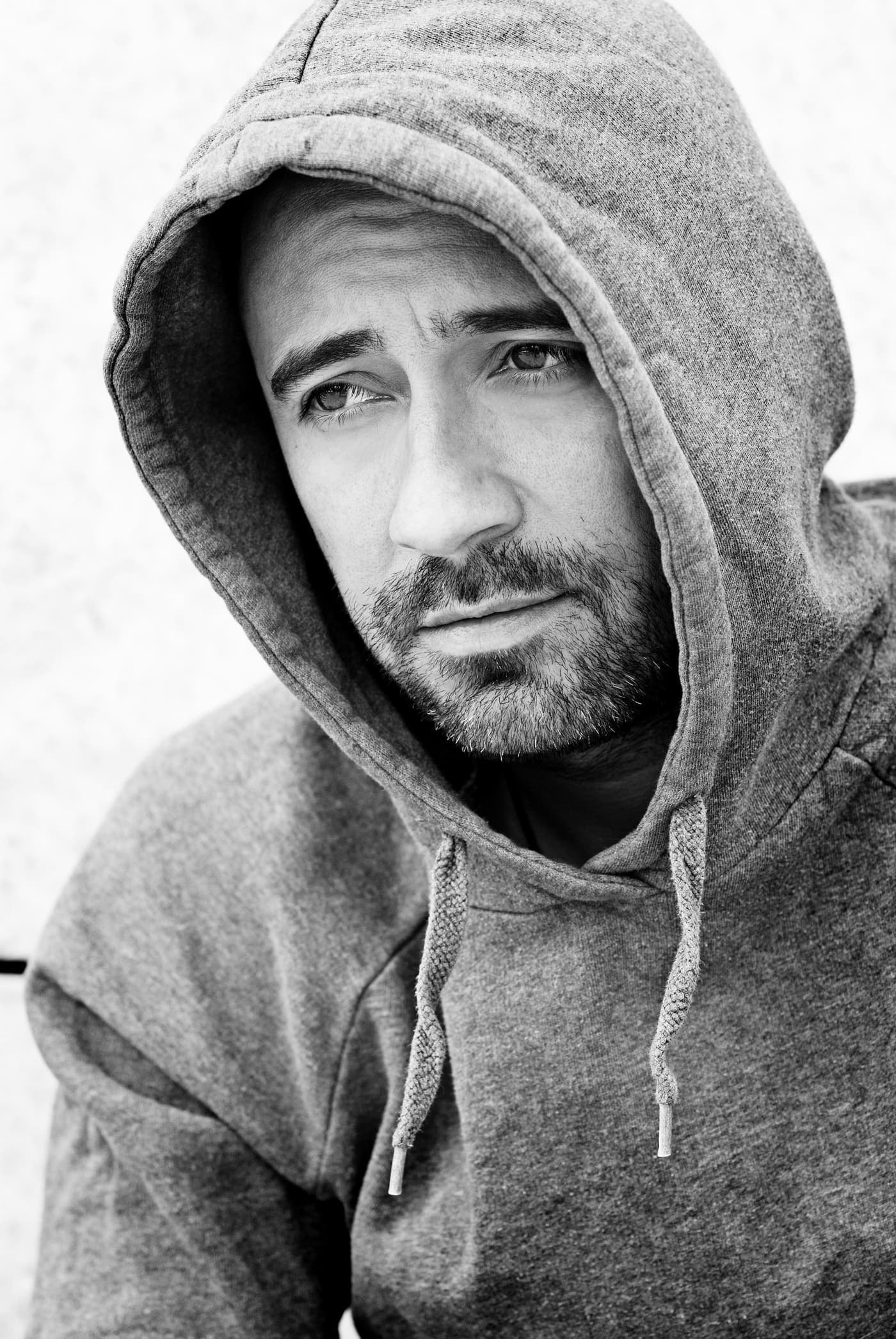 Manuel Rodriguez with his hood up, black and white portrait