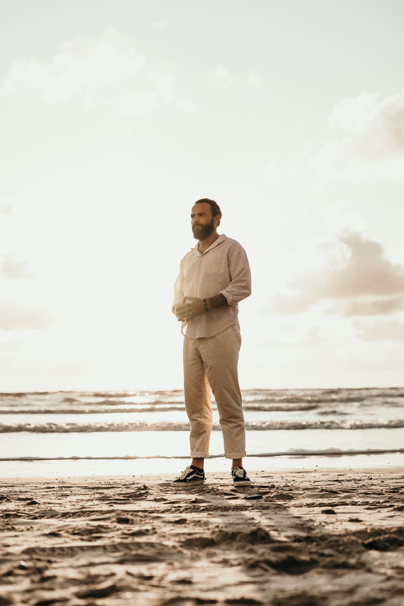 Mario Navajo on wet sand, evening sky behind him